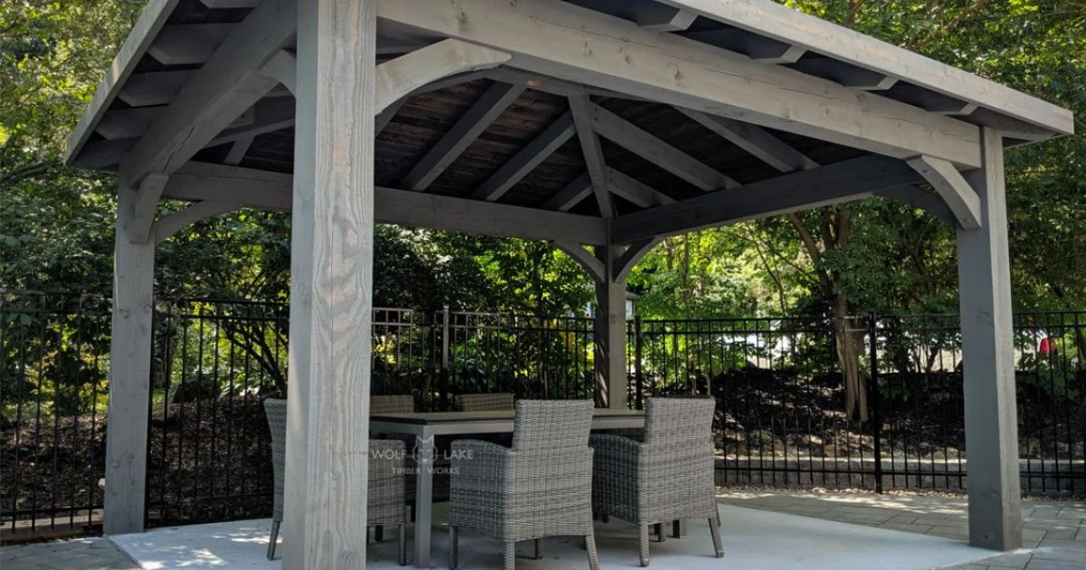 Gray timber pavilion with patio furniture